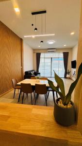 a living room with a table and a dining room at Chun Pa House in Sathani Khlong Rian