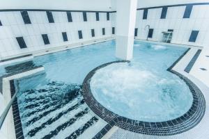 a large swimming pool in front of a building at Old Town 3Room Apartment in Tallinn