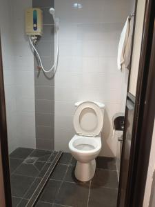 a bathroom with a toilet and a shower at SO Hotel in George Town
