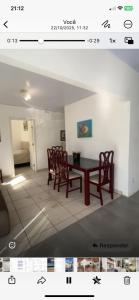 a dining room with a table and chairs at Parada dos Golfinhos in Florianópolis