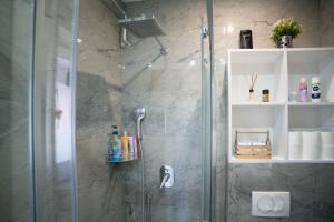 a bathroom with a shower with a glass door at Festival Centar Sarajevo in Sarajevo