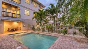 a swimming pool in front of a house at Casa Junonia - 1032L in Siesta Key