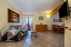 a living room with a couch and a table at Agriturismo Val d' Egoi 3 in Tremosine Sul Garda