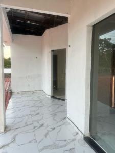 an empty room with white walls and a glass door at Lu Alter Residence in Santarém +5 photos