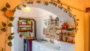 a kitchen with an archway over a stove top oven at La Casa Della Lavanda in Castelvecchio di Rocca Barbena