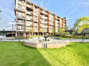 a large building with a fountain in front of it at Beachside 1BHK Apartment - Pool, Gym & Modern Comforts, Candolim in Candolim