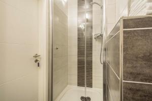 a shower with a glass door in a bathroom at Apartment für Zwei in Meersburg +12 photos