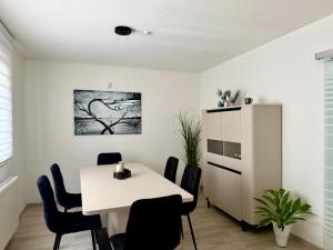 a dining room with a white table and chairs at Ferienwohnung mit Garten und Parkplatz mitten in Neumarkt in Neumarkt in der Oberpfalz