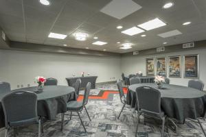 a conference room with tables and chairs with flowers on them at Inn at the Peachtrees, an Ascend Collection Hotel in Atlanta