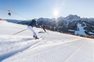 a person is skiing down a snow covered slope at App Piz de Plaies -ciasa Lavarella in San Vigilio Di Marebbe +9 photos