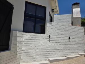 a house with a window on the side of it at Luvlé Lux Apartments in Eros Airport