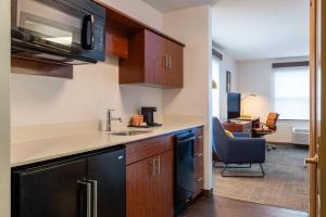 a kitchen with a sink and a desk in a room at Comfort Inn Danvers - Boston North Shore in Danvers