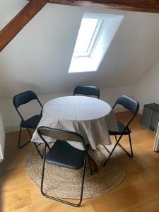 a table and chairs in a room with a window at Frihmess in Bensheim
