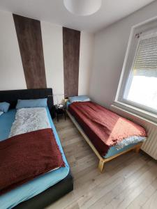 Un dormitorio con dos camas y una ventana. en Signature Living, en Burghaun