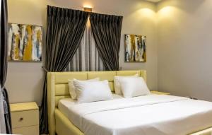 a bedroom with a large bed with a window at Zilla Luxury - Lifecamp in Abuja