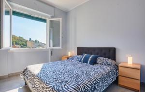 a bedroom with a bed and a large window at Nice Apartment In Zoagli With Wifi in SantʼAmbrogio