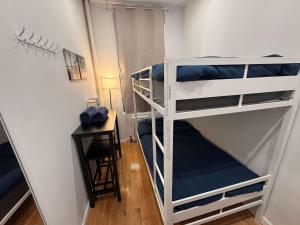 two bunk beds in a small room with a desk at Room with Kitchen in Chelsea - Shared Bathroom - 3rd Floor Walk-UP in New York