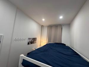 a small bedroom with a blue bed in it at Room with Kitchen in Chelsea - Shared Bathroom - 3rd Floor Walk-UP in New York