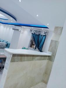 a mirror in a room with a curtain at استديو مفروش فى المهندسين ميدان لبنان برج حديث in Cairo