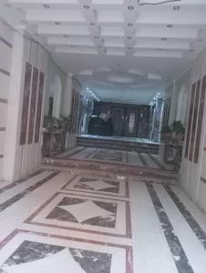 a hallway with a tile floor in a building at استديو مفروش فى المهندسين ميدان لبنان برج حديث in Cairo