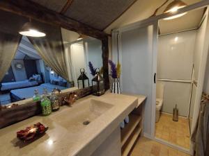 a bathroom with a sink and a large mirror at Best Luxury Camp in Merzouga +42 photos