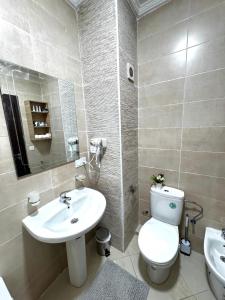 a bathroom with a white toilet and a sink at Appartement Tanger Stade ibn batouta in Tangier +19 photos