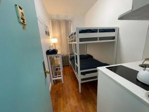a small room with a bunk bed and a kitchen at Room in Chelsea 2 with Kitchen - Shared Bathroom -5th Floor Walk-UP in New York