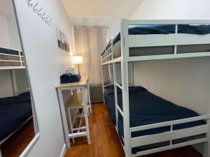a room with three bunk beds and a desk at Room in Chelsea 2 with Kitchen - Shared Bathroom -5th Floor Walk-UP in New York +15 photos