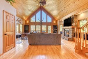 a large living room with a large couch and a fireplace at Iron Mountain - Spacious Secluded Lodge with Hot Tub & Game Room in Sandy +98 photos