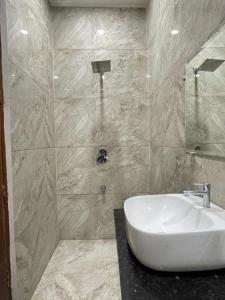a bathroom with a sink and a shower at Sonu luxury residency hotel in Amritsar