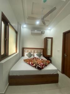a bedroom with a large bed with a blanket on it at Sonu luxury residency hotel in Amritsar