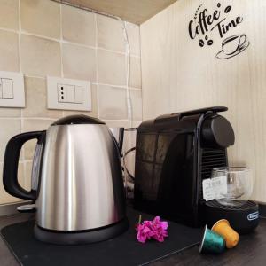 a tea kettle sitting on top of a kitchen counter at Lazulite - Sardinia Suite in Murta Maria