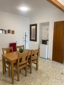 a kitchen and dining room with a wooden table and chairs at Hostal Collsacabra in L’ Esquirol