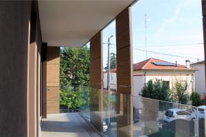 an external view of a house with glass walls at WELCOME residenza esclusiva via Liverani Imola in Imola