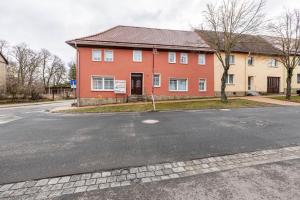 a large red house on the side of a street at Ferienwohnung im Harz in Harzgerode