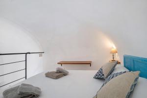 a bedroom with a white bed with two pillows at Loft nel Centro di Alassio in Alassio