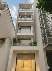 an external view of a white building with a balcony at Centraltique Veranda Living in Hanoi