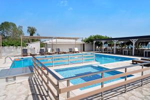 a large swimming pool with blue water at Iguana studio 3 in Preveza