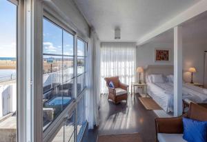 a bedroom with a bed and a balcony with a view at Refurbished Seafront Apartment in Maspalomas