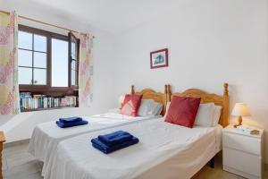 two beds in a room with two blue towels on them at Puerto Chico 9 in Playa Blanca +13 photos
