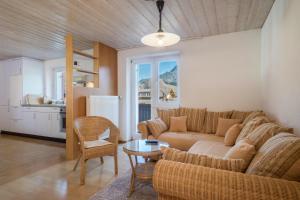 a living room with a couch and a table at Wohnung Kanisfluhblick in Bizau