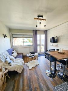 a living room with a couch and a piano at Appartement avec chambre Gourette in Gourette +15 photos