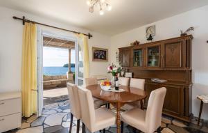 a dining room with a table and chairs at Beach house Lozica by Villas Guide in Dubrovnik