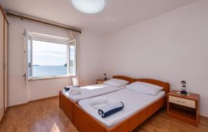 a bedroom with a bed with a large window at Beach house Lozica by Villas Guide in Dubrovnik