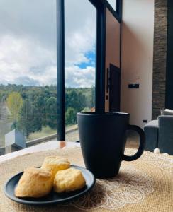 a plate of biscuits on a table next to a coffee cup at El filo del Lolog in San Martín de los Andes