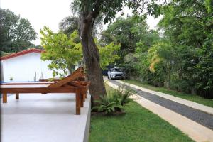 a pool table next to a tree in a yard at Hotel sunflower in Dambulla