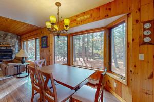 a dining room with a table and chairs in a cabin at Camp Farrell House in Manitowish Waters