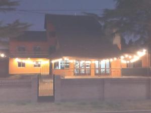 a house lit up at night with lights at Hostal Viví La Pampa in Santa Rosa