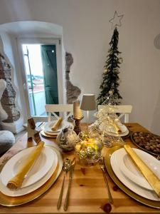 a dining room table with christmas decorations and a christmas tree at Casa Rustica in Mali Lošinj