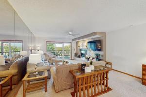 a living room with a couch and a table at Whispering Breeze Condo in Laguna Beach